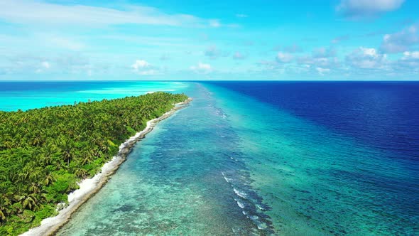 Beautiful drone travel shot of a white paradise beach and aqua blue water background in vibrant 4K