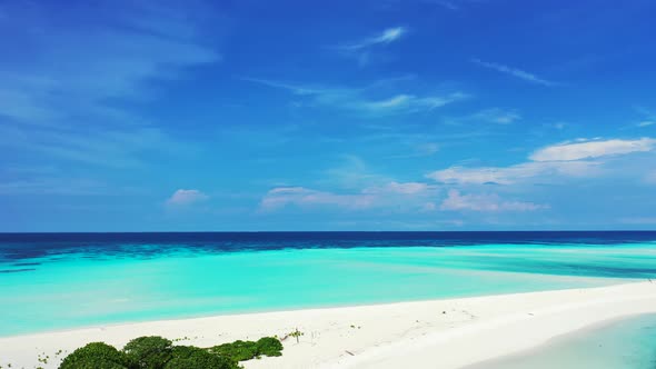 Daytime fly over copy space shot of a sunshine white sandy paradise beach and blue ocean background 