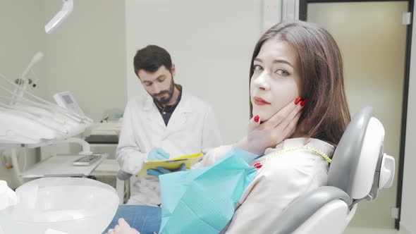 Young Woman with Toothache Visiting Dentist