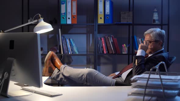 Thoughtful executive with her feet on the table