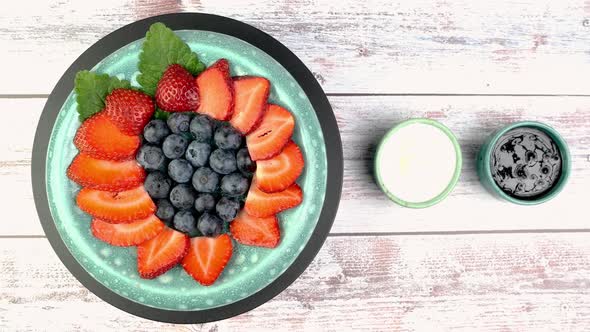 Dessert with Strawberries and Blueberries with Yogurt or Whipped Cream Rotate Slowly on Turntable