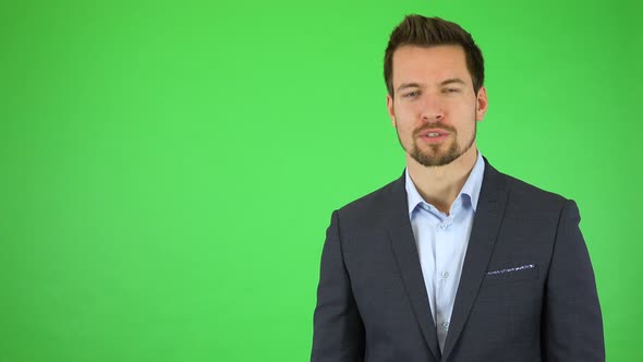 A Young Handsome Businessman Talks To the Camera with a Smile, Then Turns and Walks Out of the Frame