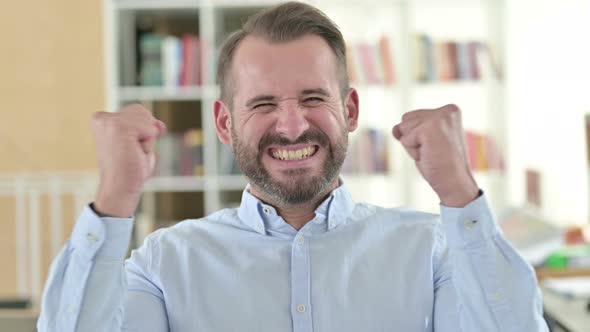 Portrait of Positive Young Man Celebrating Success, Joy 