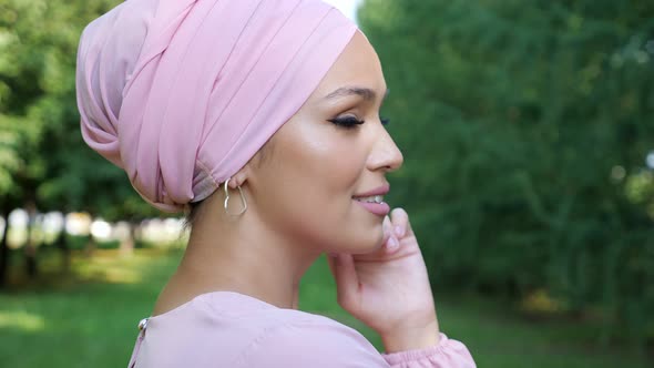 Fashionable Young Woman in Hijab Turns Head and Smiles