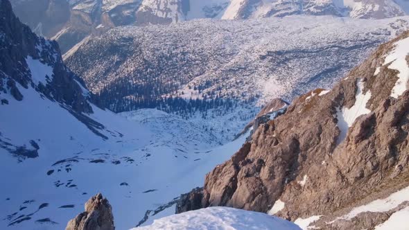 Magnificent Horizontal Pan of Snowy Mountain Range, Trees in Beautiful Valley