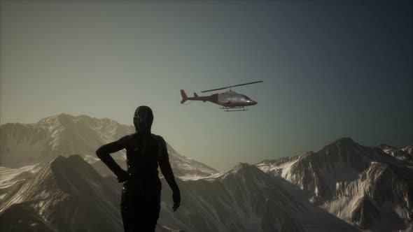 Woman and Helicopter in Winter Mountains