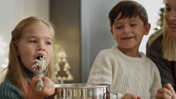 Video of little girl tasting sugar paste during baking with brother