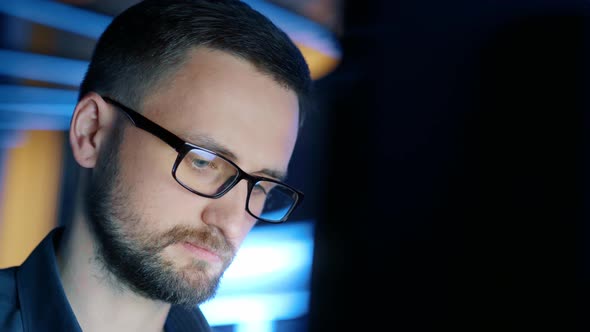 Closeup of a Concentrated Man in Glasses Who Works at a Computer