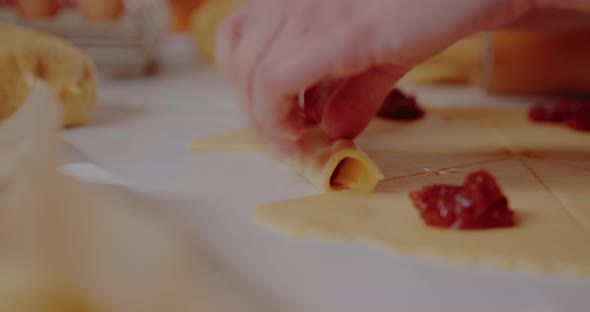 Woman Making Tasty Croissants on Table in Kitchen