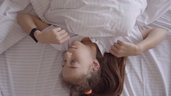 Adorable Small Girl Sleeping in The Bed at Home