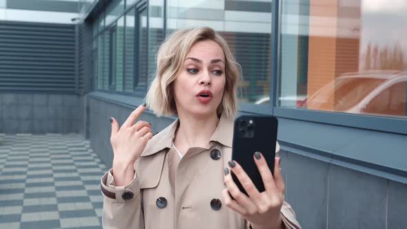 Smiling Business Woman Having Video Call on Mobile Phone Outdoors