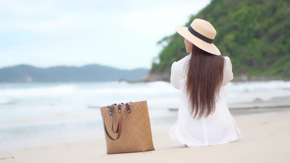 Asian woman enjoy around beautiful beach sea ocean