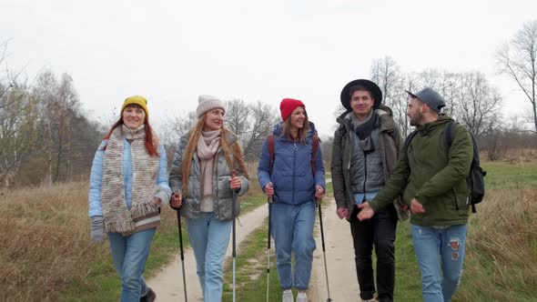 Group of Hikers Walking on a Mountain at Autumn Day