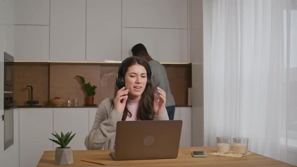 Young Woman Having a Voice Call and Asking Her Husband for Help Indoors