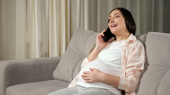 Pregnant Brunette Woman Talks Via Phone Stroking Large Belly