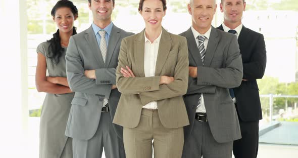 Smiling Business People Looking at Camera with Arms Crossed