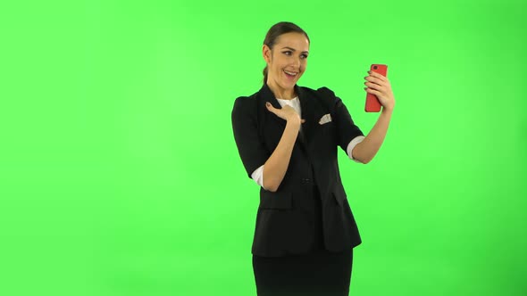 Smiling Girl Talking for Video Chat Using Mobile Phone and Rejoice. Green Screen