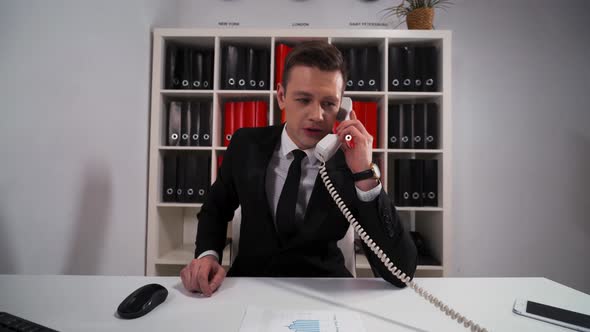 Handsome Businessman Ask You Wait and Precise Some Your Questions By Telephone