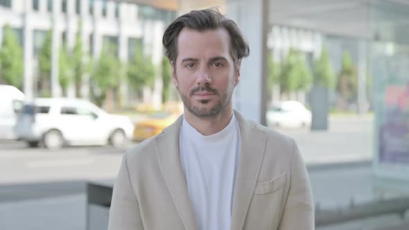 Outdoor Portrait of Young Man Looking at the Camera