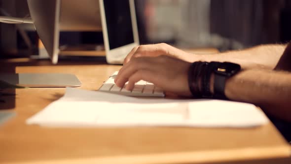 Overtime Work In Office. Man Typing On Keyboard At Night. Man Working In Office And Writing Message.