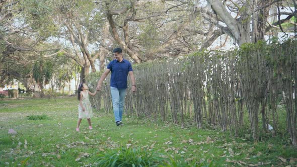 Dad and Daughter Walking in the Park
