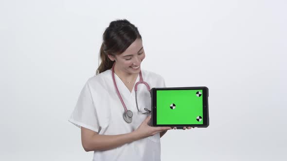 Doctor looking at tablet smiling and giving thumbs up