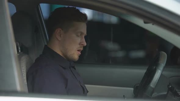 Confident Policeman Sitting in Patrol Car and Wearing Sunglasses, Ready for Work