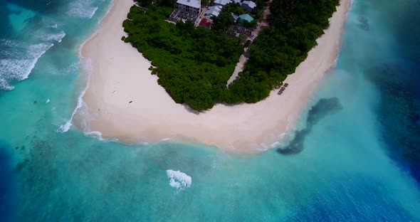 Daytime flying island view of a paradise sunny white sand beach and blue water background in colourf