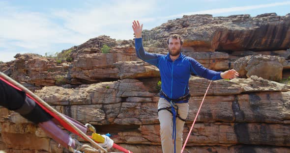 Mountaineer starts walking on the tightrope 4k