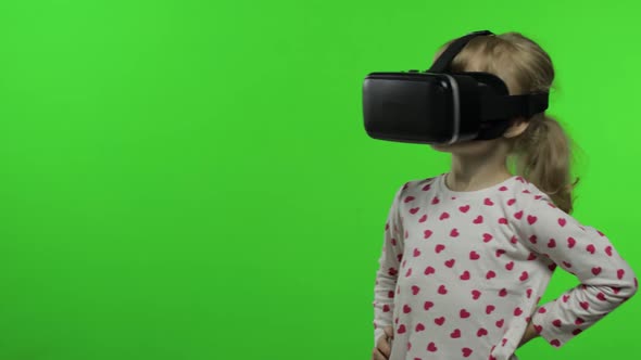 Child Girl Using VR Helmet To Play Simulation Game App. Watch Virtual Reality 3d Video. Chroma Key