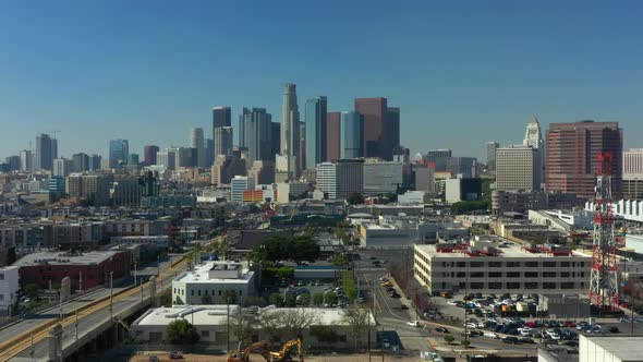 Rising Crane Shot of the Downtown Los Angeles Skyline on a bright day with carsing California, USA