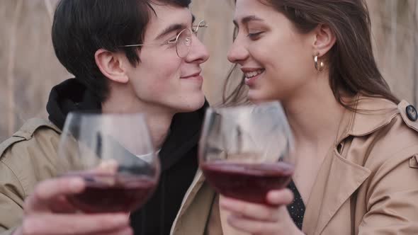 Portrait of Man and Woman Holding Glasses of Red Wine