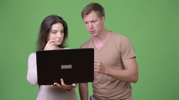 Young Couple Using Laptop and Thinking Together