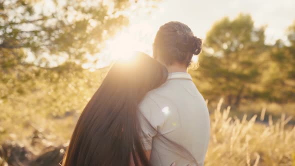 Young Girl Leaning On Her Boyfriend Broad Shoulder While Hugging And Watching The Beautiful Sunset