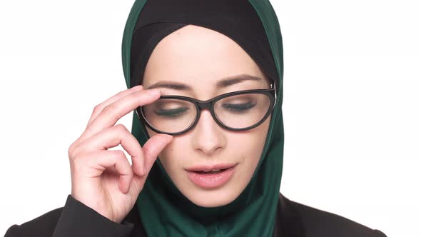 Portrait of Gorgeous Arabic Woman in Traditional Scarf and Eyeglasses Posing on Camera with Charming