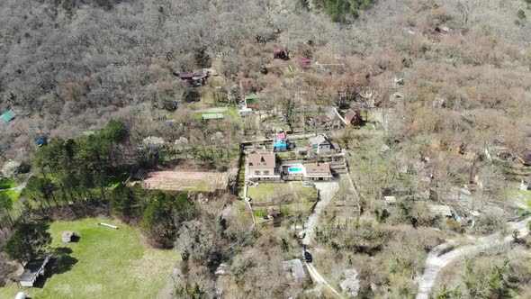 Flying over the forest. Flying over a mountain village. Caucasus mountains.