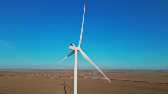 Aerial View of Autumn Countryside with Wind Turbines and Agricultural Fields on Sea Coast Background