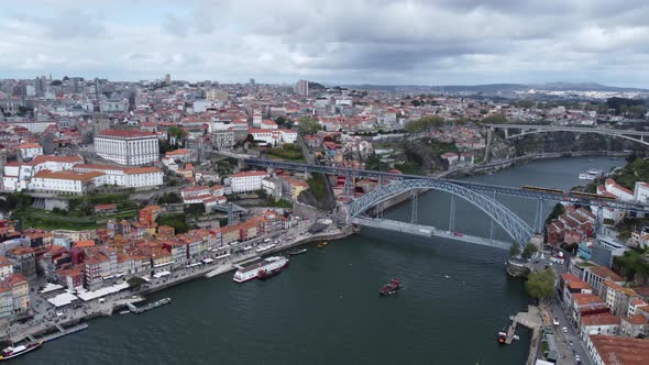 Panorama Of Porto Old Town And Dom Luis Bridge On A Cloudy Day In Porto, Portugal. Aerial Wide Shot