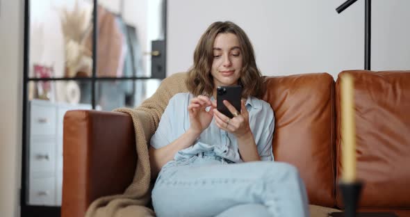 Woman with a Smart Phone at Cozy Home