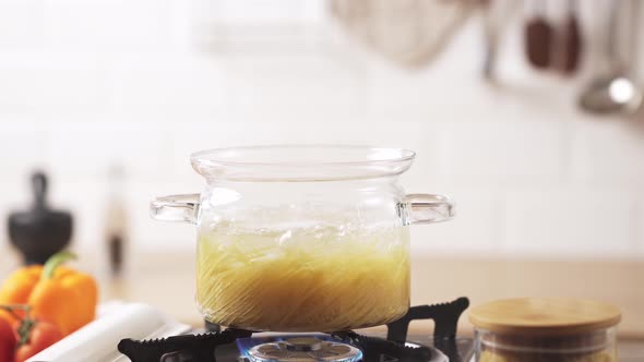 Boil Boiled Spaghetti Pasta. Cooking Pasta In Water. Transparent Saucepan Stands On The Gas