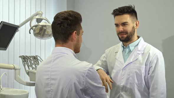 Two Dentists Shake Hands at the Office