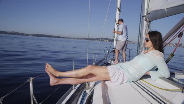 Young woman relaxing on sailboat. Shot on RED EPIC for high quality 4K, UHD, Ultra HD resolution.