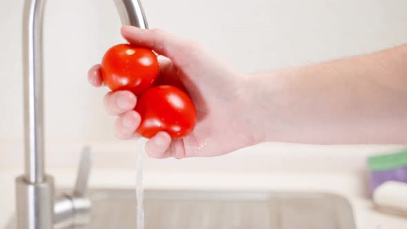 Shaking Washed Red Tomatoes From the Water and Turning Off the Water Closeup