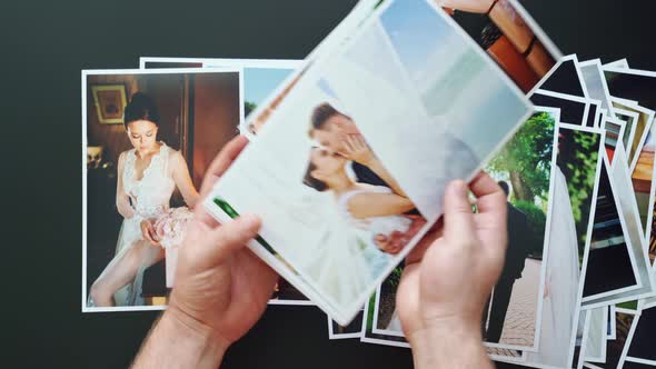 Hands Lay Out Wedding Photos