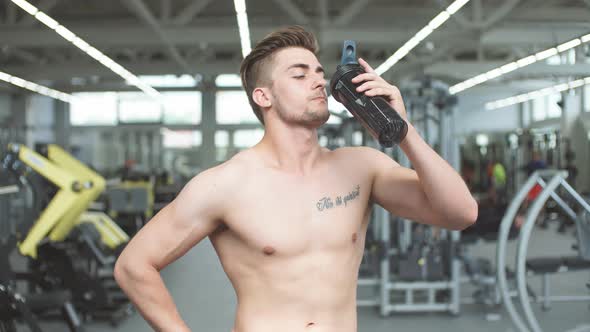 Handsome Man Resting During a Workout at the Gym