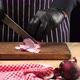 man chef in a black striped apron cuts fresh onions - VideoHive Item for Sale