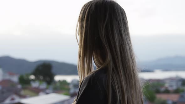 Overview Footage of a Blonde Woman Admires the View Standing at Nice Viewpoint