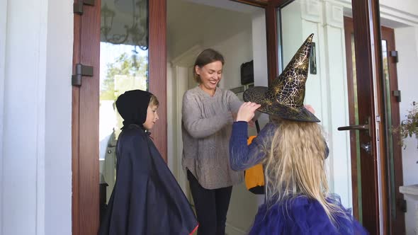 Mother Dressing Up Children on Trick-Or-Treating Walk Halloween Holiday for Kids