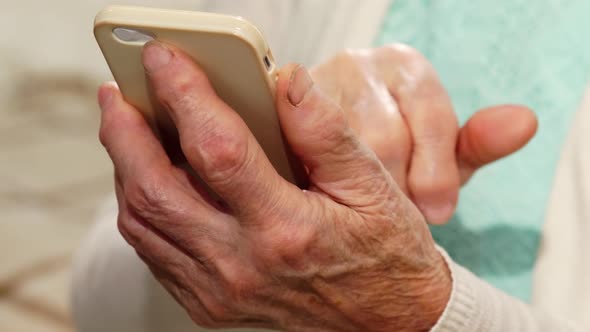 Hands of Senior Woman Using Smartphone