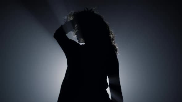 Silhouette Sexy Girl Dancing in Darkness
